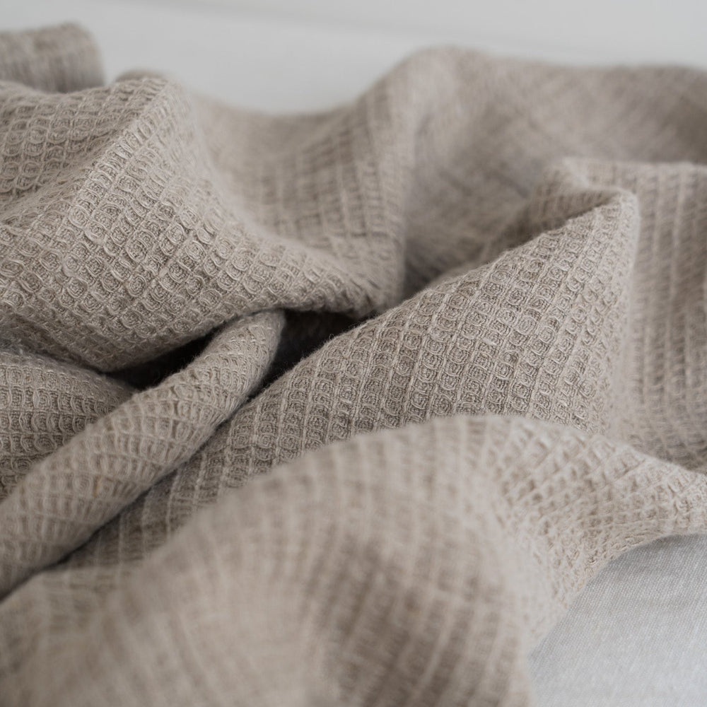 Close-up of a textured beige fabric on a light background