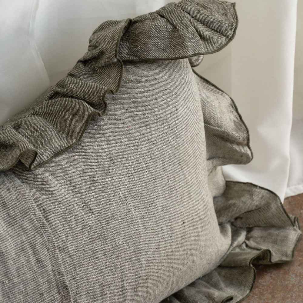 Textured pillow with ruffled edge on a soft surface