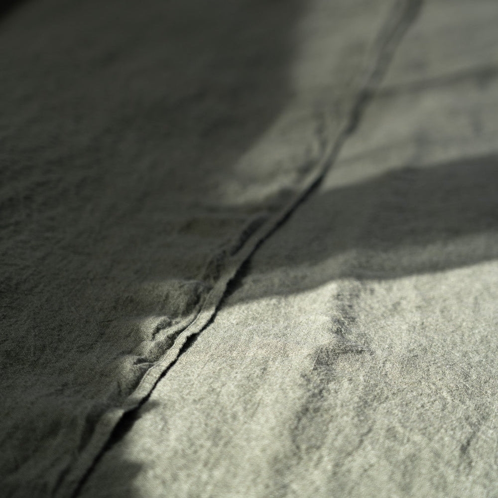 Close-up of a textured linen in olive green