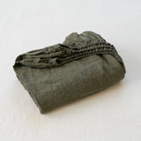 Folded green fabric on a white background